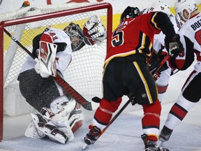 Ottawa Senators goalie Craig Anderson, left, is pushed into the net as Calgary Flames' Mark Giordano scores during first period NHL hockey action in Calgary, Thursday, March 21, 2019.THE CANADIAN PRESS/Jeff McIntosh
