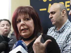 Lynda Poirier of the suicide prevention centre responds to reporters questions as taxi industry spokes person Abdallah Homsy reacts, Friday, March 29, 2019 in Quebec City. A taxi driver attempted to kill himself earlier during a live television newscast.