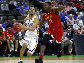 LSU's Tremont Waters, left, goes to the basket past Maryland's Darryl Morsell (11) during the first half of a second-round game in the NCAA men's college basketball tournament in Jacksonville, Fla., Saturday, March 23, 2019.