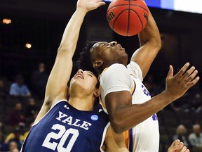 Yale 's Paul Atkinson (20) and LSU's Kavell Bigby-Williams battle for a rebound during the first half of a first round men's college basketball game in the NCAA Tournament in Jacksonville, Fla. Thursday, March 21, 2019.