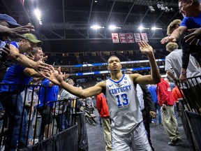 Kentucky's Jemarl Baker Jr. (13) is greeted by fans as he leaves the court after defeating Wofford in a second-round game in the NCAA men's college basketball tournament in Jacksonville, Fla., Saturday, March 23, 2019.