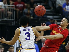 LSU's Tremont Waters (3) and Maryland's Anthony Cowan Jr. go after a loose ball during the first half of a second-round game in the NCAA men's college basketball tournament in Jacksonville, Fla., Saturday, March 23, 2019.