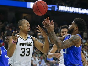 Wofford's Cameron Jackson (33) and Seton Hall's Myles Powell, right, go after a loose ball during the first half of a first-round game in the NCAA men's college basketball tournament in Jacksonville, Fla., Thursday, March 21, 2019.