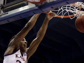 Kansas' Ochai Agbaji dunks the ball during the first half of an NCAA college basketball game against Baylor Saturday, March 9, 2019, in Lawrence, Kan.