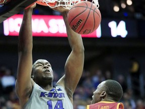 Kansas State forward Makol Mawien (14) dunks over Iowa State forward Cameron Lard (2) during the first half of an NCAA college basketball game in the semifinals of the Big 12 Conference tournament in Kansas City, Mo., Friday, March 15, 2019.