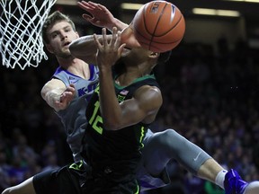 Kansas State forward Dean Wade, back, covers Baylor guard Jared Butler (12) during the first half of an NCAA college basketball game in Manhattan, Kan., Saturday, March 2, 2019.