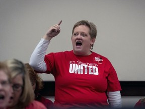 Kristin Walker, a Jefferson County teacher shouts in a hearing room to protest a bill that would change how individuals are nominated to the Kentucky teachers retirement systems board of trustees, in Frankfort,, Ky, Thursday, Feb 28, 2019.