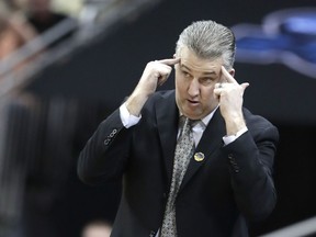 Purdue head coach Matt Painter watches the action during the first half of a men's NCAA Tournament college basketball South Regional semifinal game Tennessee Thursday, March 28, 2019, in Louisville, Ky.