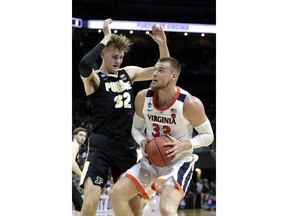 Virginia's Jack Salt (33) goes to the basket against Purdue's Matt Haarms (32) during the first half of the men's NCAA Tournament college basketball South Regional final game, Saturday, March 30, 2019, in Louisville, Ky.