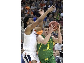 Oregon's Payton Pritchard (3) drives against Virginia's Braxton Key, left, during the first half of a men's NCAA Tournament college basketball South Regional semifinal game, Thursday, March 28, 2019, in Louisville, Ky.