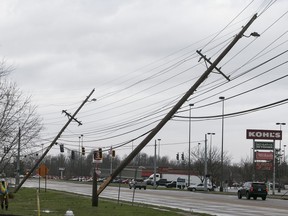 Power lines are down in Paducah, Ky. on Thursday, March 14, 2019.   This Thursday, March 14, 2019 photo shows damage to the Wilbert Vault Co., in West Paducah, Ky.  A tornado left a path in western Kentucky from Lovelaceville through the West Paducah area, according to Keith Todd, a spokesman for the Kentucky Transportation Cabinet. He said the public was being asked to avoid the area while utility crews, area fire departments, and rescue squads worked to clear utility lines, downed trees and other debris.