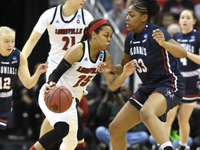 Louisville guard Asia Durr (25) attempts to drive past the defense of Robert Morris center Nneka Ezeigbo (33) during the first half of a first-round game in the NCAA women's college basketball tournament in Louisville, Ky., Friday, March 22, 2019.