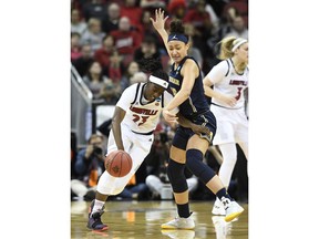 Louisville guard Jazmine Jones (23) tries to get past the defense of Michigan forward Hailey Brown (15) during the first half of a second-round game in the NCAA women's college basketball tournament in Louisville, Ky., Sunday, March 24, 2019.