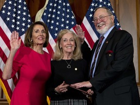 FILE - In this Jan. 3, 2019, file photo, House Speaker Nancy Pelosi of Calif., left, administers the House oath of office to Rep. Don Young, R-Alaska, with his wife, Anne Garland Walton, middle, during ceremonial swearing-in on Capitol Hill in Washington during the opening session of the 116th Congress. U.S. Rep. Don Young was feted for becoming the longest-serving Republican in House history. Young, who was re-elected in November, marked 46 years in the House Wednesday, March 6. He surpasses the late former Speaker Joseph Cannon to become the longest-serving Republican. House Speaker Nancy Pelosi thanked Young for being "a leader of merit and character." Young thanked his colleagues for recognizing his tenure.