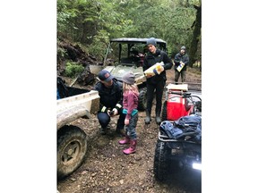 In this Sunday, March 3, 2019 photo provided by the Humboldt County Sheriff's Office, Caroline Carrico is assessed by search crews after being found near Benbow, Calif. Armed with some outdoor survival training, granola bars and pink rubber boots, 8-year-old Leia Carrico and 5-year-old Caroline Carrico survived 44 hours in the rugged Northern California wilderness before they were found dehydrated and cold but in good spirits on Sunday, authorities said. (Humboldt County Sheriff's Office via AP)