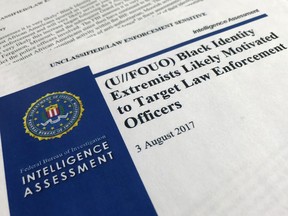 FILE - In this Nov. 17, 2017, file photo, the cover page of a FBI report on the rise of black "extremists" is photographed in Washington. The report is stirring fears of a return to practices of the Civil Rights era, when the agency notoriously spied on activist groups without evidence they had broken any laws. The American Civil Liberties Union and others are suing the FBI for records to find out more about a divisive 2017 report on the rise of black "extremists" following the shooting deaths of African-Americans. The FBI released an intelligence assessment in 2017 saying that "black identity extremists" were targeting law enforcement after police killings of black men. Critics say they fear the FBI is using the assessment to profile blacks who speak out against police violence.