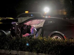 New Orleans Police Department officers process a damaged vehicle after responding to a fatal hit and run accident along Esplanade Avenue in Bayou St. John in New Orleans, Saturday, March 2, 2019. Authorities say several people have been killed and others injured after being struck by a vehicle on a busy New Orleans thoroughfare.