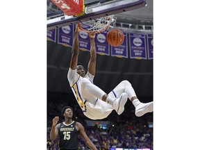 LSU forward Kavell Bigby-Williams (11) dunks the ball in front of Vanderbilt forward Clevon Brown (15) in the first half of an NCAA college basketball game, Saturday, March 9, 2019, in Baton Rouge, La.