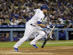 Los Angeles Dodgers' A.J. Pollock follows through on a bases-loaded two-RBI single against the Arizona Diamondbacks during the third inning of a baseball game Friday, March 29, 2019, in Los Angeles.