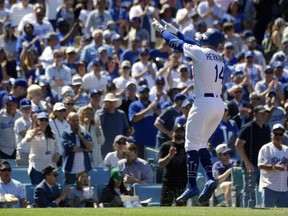 Los Angeles Dodgers' Enrique Hernandez gestures toward the crowd after hitting a two-run home run during the fourth inning of a baseball game against the Arizona Diamondbacks, Thursday, March 28, 2019, in Los Angeles.