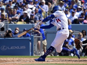 Los Angeles Dodgers' Enrique Hernandez hits a two-run home run during the fourth inning of a baseball game against the Arizona Diamondbacks, Thursday, March 28, 2019, in Los Angeles.