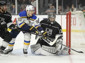 Los Angeles Kings goaltender Jonathan Quick, right, defects the puck away as St. Louis Blues left wing Alexander Steen, center, reaches for it along with defenseman Alec Martinez during the first period of an NHL hockey game Thursday, March 7, 2019, in Los Angeles.