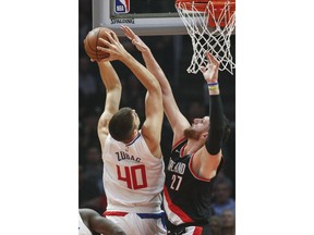 Los Angeles Clippers' Ivica Zubac, left, goes to basket as Portland Trail Blazers' Jusuf Nurkic defends during the first half of an NBA basketball game Tuesday, March 12, 2019, in Los Angeles.