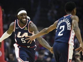 Los Angeles Clippers forward Montrezl Harrell, left, celebrates with guard Shai Gilgeous-Alexander after making a basket during the first half of an NBA basketball game against the Cleveland Cavaliers in Los Angeles, Saturday, March 30, 2019.