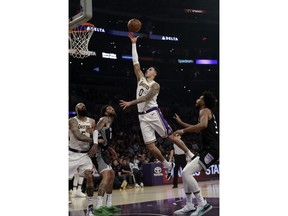 Los Angeles Lakers' Kyle Kuzma (0) scores against the Sacramento Kings during the first half of an NBA basketball game Sunday, March 24, 2019, in Los Angeles.