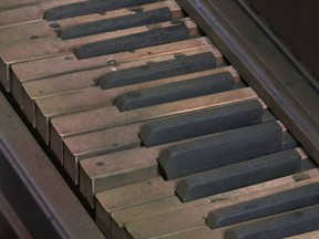 In this March 15, 2019 image taken from video, piano keys, stained and damaged to look as though they were in a once-flooded room, part of a re-creation of flood damage in a new exhibit in New Orleans by the organization Levees.org. The organization is unveiling the exhibit Saturday, March 23, in a house near the site of one of the floodwall failures that led to inundation of New Orleans when Hurricane Katrina struck in 2005.
