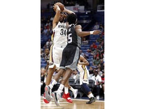 New Orleans Pelicans guard Kenrich Williams (34) is hit in the face by Sacramento Kings guard De'Aaron Fox (5) during the first half of an NBA basketball game in New Orleans, Thursday, March 28, 2019.