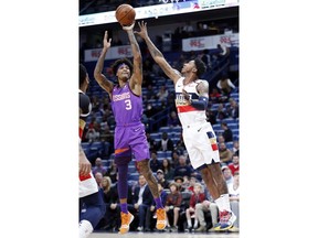 Phoenix Suns forward Kelly Oubre Jr. (3) shoots over New Orleans Pelicans guard Elfrid Payton (4) during the first half of an NBA basketball game in New Orleans, Saturday, March 16, 2019.