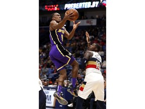 Los Angeles Lakers guard Rajon Rondo (9) drives to the basket in front of New Orleans Pelicans forward Cheick Diallo (13) during the first half of an NBA basketball game in New Orleans, Sunday, March 31, 2019.