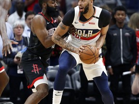New Orleans Pelicans forward Anthony Davis (23) is defended by Houston Rockets guard James Harden, left, during the first half of an NBA basketball game in New Orleans, Sunday, March 24, 2019.