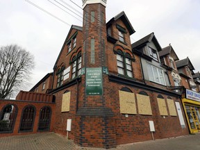 The mosque in Erdington, Birmingham, central England, Thursday March 21, 2019, with its windows boarded up after apparently being smashed with a sledgehammer. Counter-terrorism officers in central England are investigating attacks on five mosques in which windows were apparently shattered by a sledgehammer.