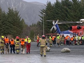 Passengers rescued from the Viking Sky cruise ship are helped from a helicopter in Hustadvika, Norway, Saturday March 23, 2019. A cruise ship with engine problems sent a mayday call off Norway's western coast on Saturday, then began evacuating its 1,300 passengers and crew amid stormy seas and heavy winds in a high-risk helicopter rescue operation.