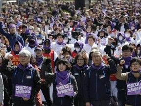 Members of the Korean Confederation of Trade Unions attend during a rally to mark the International Women's Day in downtown Seoul, South Korea, Friday, March 8, 2019. More than a thousand people attended at a rally demanding better working condition for women workers and gender equality. The banners read "Gender equality."