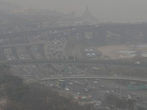 Vehicles move near the Han river in Seoul, South Korea, Tuesday, March 5, 2019. South Korean Environment Ministry issued emergency fine dust reduction measures on Tuesday.
