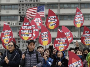Protesters hold signs during a rally demanding the denuclearization of the Korean Peninsula and peace treaty near the U.S. embassy in Seoul, South Korea, Thursday, March 21, 2019. The Korean Peninsula remains in a technical state of war because the 1950-53 Korean War ended with an armistice, not a peace treaty. More than 20 protesters participated at a rally and also demanding the end the Korean War and to stop the sanction on North Korea. The letters read "Restarting operations at Kaesong industrial complex and Diamond Mountain resort."