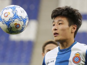FILE - In this Tuesday, Jan. 29, 2019 file photo, newly signed Espanyol soccer player Wu Lei eyes the ball during his official presentation at RCDE stadium in Cornella Llobregat, Spain. When Barcelona takes on city rival Espanyol on Saturday March 30, 2019, the Catalan derby will feature Lionel Messi, the Argentina star the world is used to watching, and the Wu Lei, the Chinese sensation that China is starting to fall in love with.