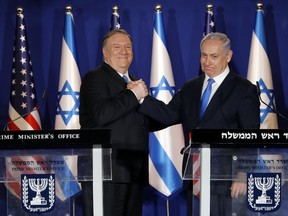 U.S. Secretary of State Mike Pompeo, left, shakes hands with Israeli Prime Minister Benjamin Netanyahu, during their visit to Netanyahu's official residence in Jerusalem, Thursday March 21, 2019. Netanyahu has praised U.S. President Donald Trump's recognition of its control over the Golan Heights as a holiday "miracle."