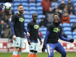Chelsea's Callum Hudson-Odoi, right, warms up with teammates wearing an anti racist campaign 'Kick It Out' T-shirt prior to their English Premier League soccer match against Cardiff, at the Cardiff City Stadium in Cardiff, Wales, Sunday March 31, 2019.