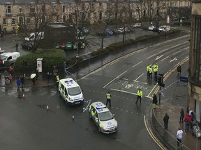 The scene as police secure the area outside the University of Glasgow, Scotland, after a suspicious package was found the university, Wednesday March 6, 2019. Police Scotland says officers are examining items found Wednesday morning at the University of Glasgow and the Royal Bank of Scotland headquarters in Edinburgh.