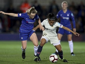 Chelsea Women's Erin Cuthbert, left, in action with Paris Saint-Germain Women's Perle Morroni during their Women's Champions League quarter final first leg match at the Cherry Red Records Stadium in London, Thursday March 21, 2019.
