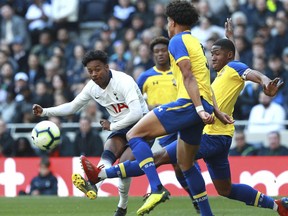 J'Neil Bennett, left, scores his side's first goal of the game against Southampton, during the U18 Premier League test event match at Tottenham Hotspur Stadium in London, Sunday March 24, 2019.  Tottenham played Southampton in an Under-18 game in the first official test event at the newly opened 62,000-seater arena, and Spurs winger J'Neil Bennett scored the first-ever goal at the stadium on Sunday.