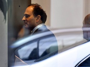 David Sidoo, of Vancouver, Canada, enters an adjacent building with his lawyer following a federal court hearing Friday, March 15, 2019, in Boston. Sidoo faced charges of conspiracy to commit mail and wire fraud as part of a wide-ranging college admissions bribery scandal.