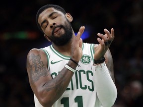 Boston Celtics guard Kyrie Irving (11) celebrates near the end of an NBA basketball game against the Sacramento Kings, Thursday, March 14, 2019, in Boston.