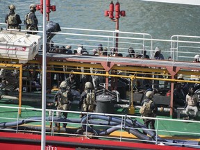 Armed forces stand onboard the Turkish oil tanker El Hiblu 1, which was hijacked by migrants, in Valletta, Malta, Thursday March 28, 2019. A Maltese special operations team on Thursday boarded a tanker that had been hijacked by migrants rescued at sea, and returned control to the captain, before escorting it to a Maltese port.