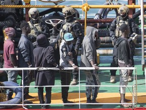Armed forces stand onboard the Turkish oil tanker El Hiblu 1, which was hijacked by migrants, in Valletta, Malta, Thursday March 28, 2019. A Maltese special operations team on Thursday boarded a tanker that had been hijacked by migrants rescued at sea, and returned control to the captain, before escorting it to a Maltese port.