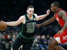 Boston Celtics' Gordon Hayward (20) drives past Houston Rockets' Gary Clark (6) during the first half of an NBA basketball game in Boston, Sunday, March 3, 2019.